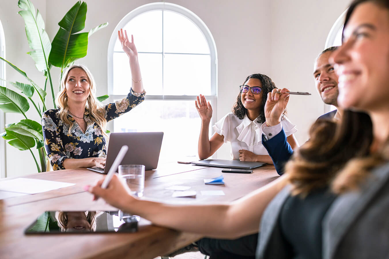 employee raising hand in conflict management training course discussing conflict resolution skills