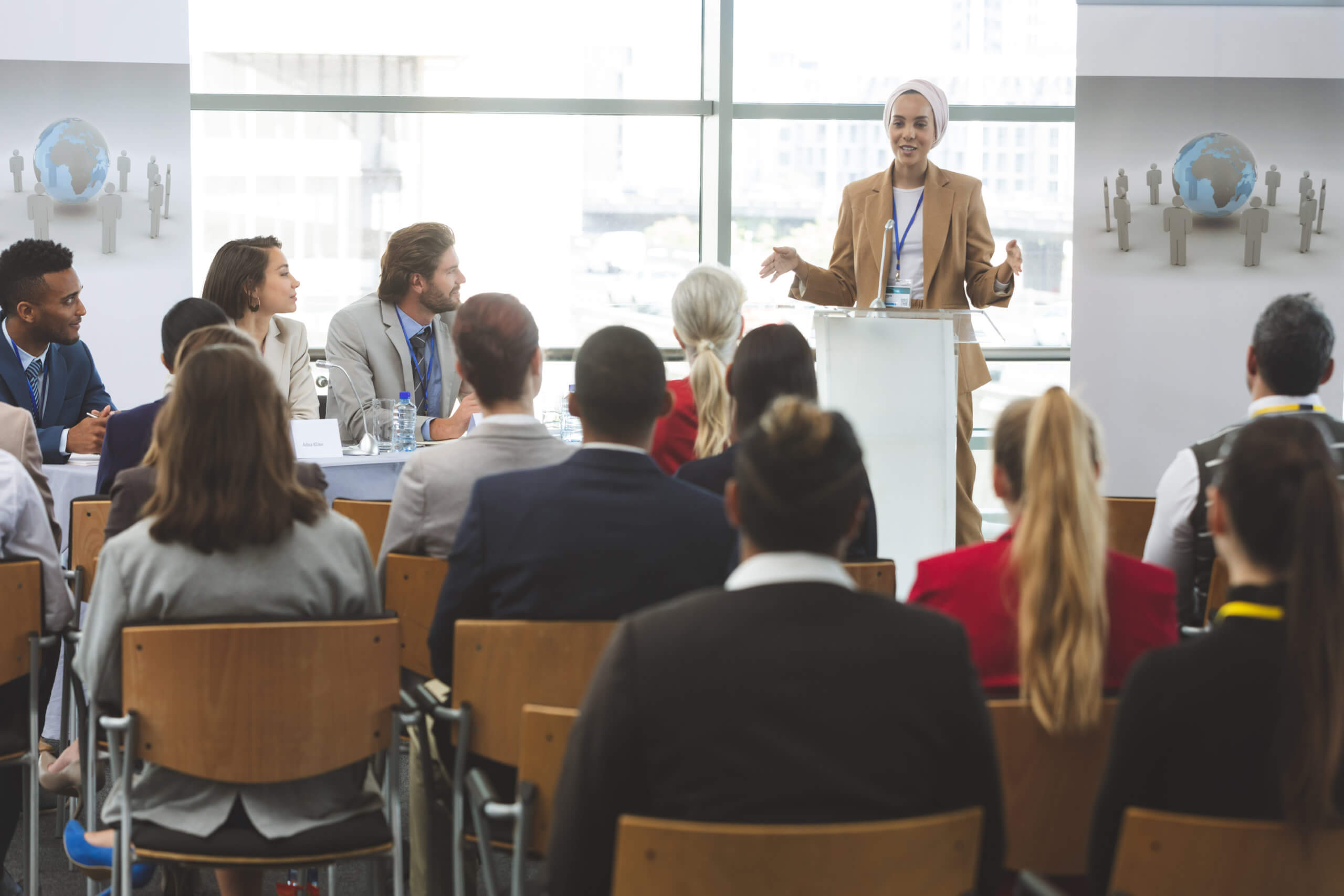 Female DEI presenter training a group of corporate employees