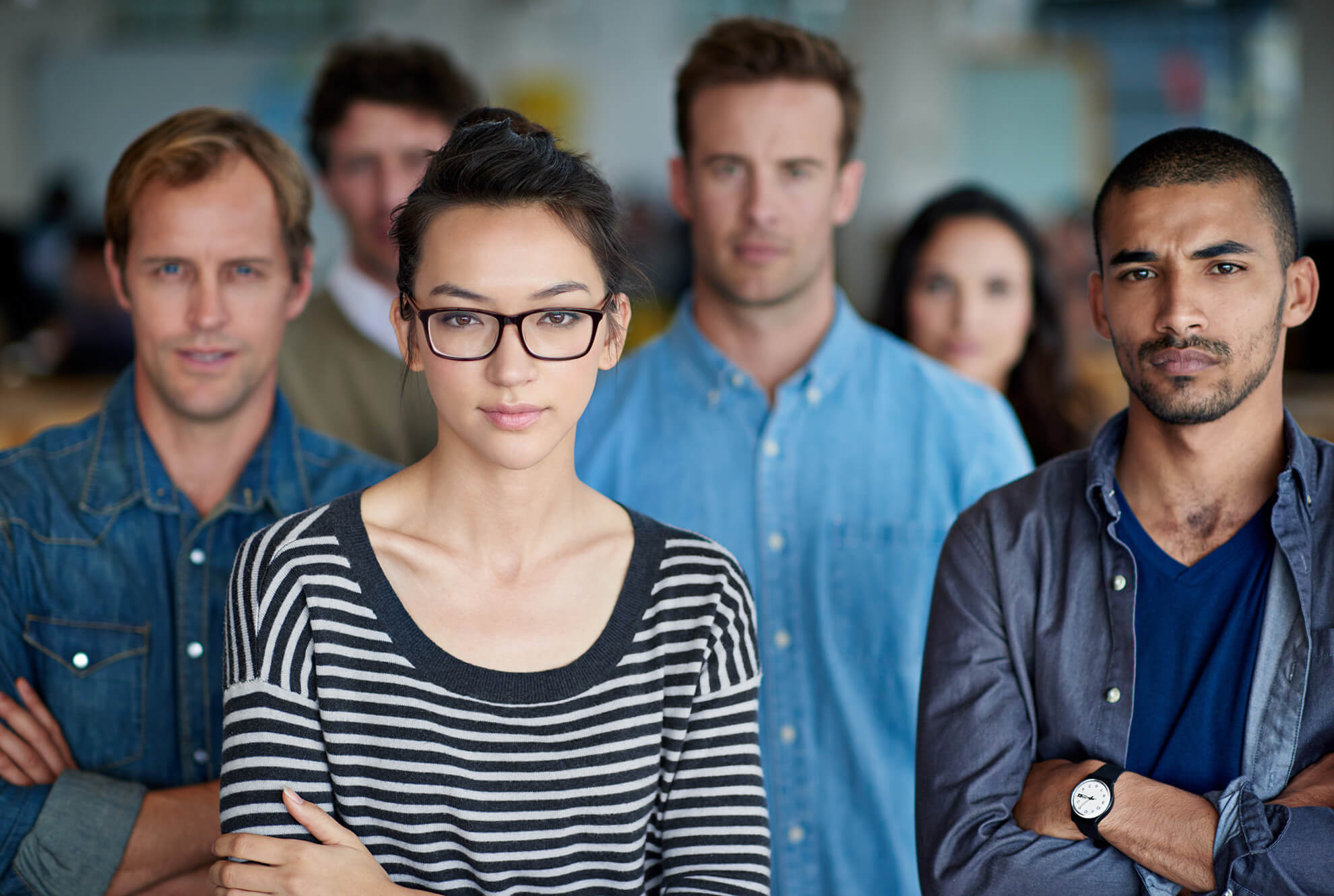 Diverse work team with serious faces standing up for sexual harassment prevention training