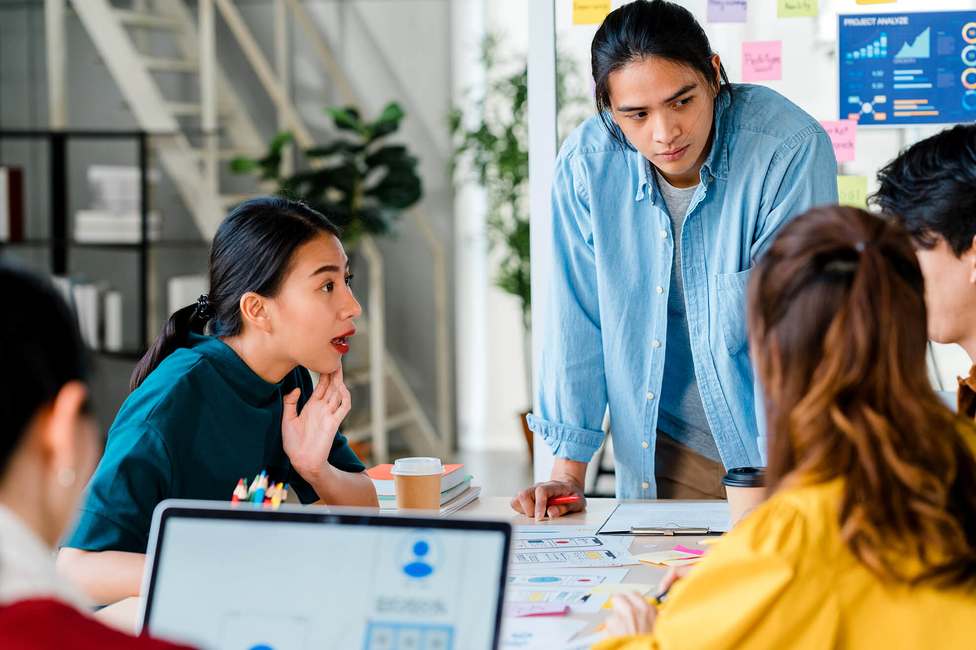 Multiracial group of young coworkers discussing their conflict management issues