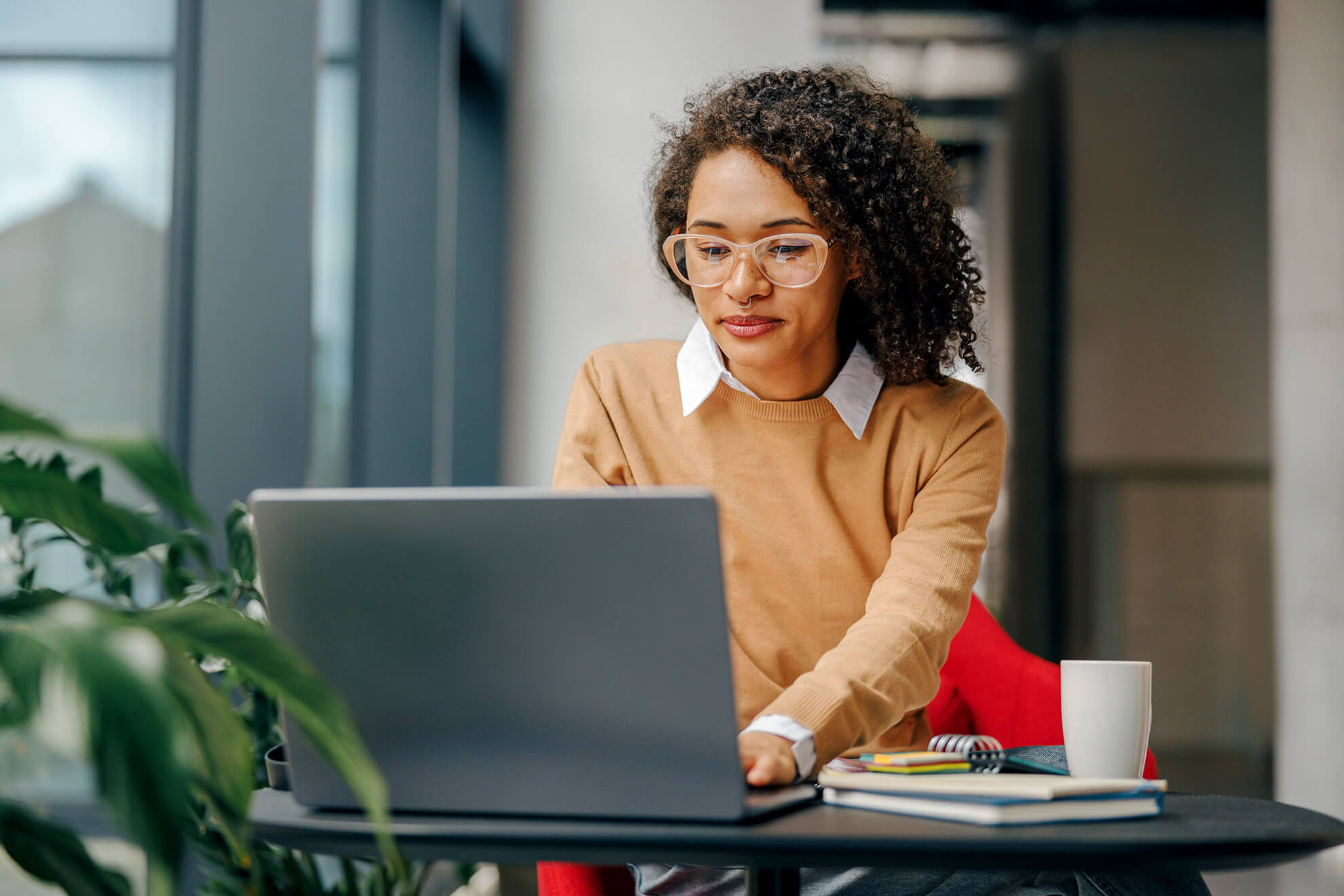 Young stylish business women taking online sexual harassment training on her work laptop